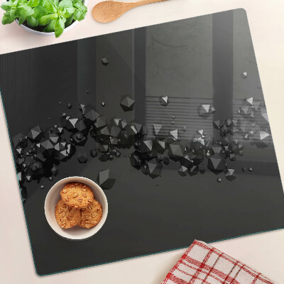 Glasschneidebrett Schwarze Kristalle auf dem Hintergrund