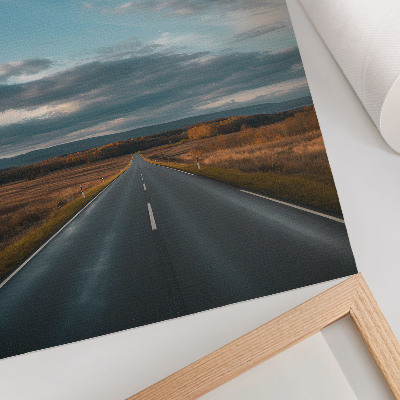 Kunstdruck leinwand Eine Straße durch die Herbstebene unter blauem Himmel
