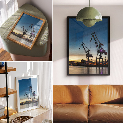 Wandposter Kräne vor der Kulisse eines dynamischen Sonnenuntergangs