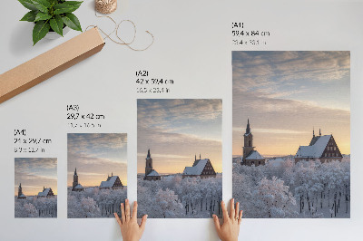 Wandposter Winterlandschaft mit einer schneebedeckten Kirche