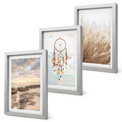 Fotowand Meerblick mit Wolken, Traumfänger und Gras