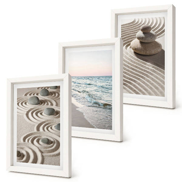 Fotowand Ruhige Wellen aus Sand und Wasser mit Steinen am Strand