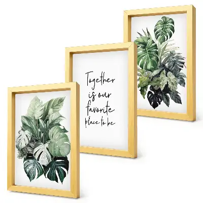Bilderwand mit Motiv von grünen Tropenblättern und dekorativem Schriftzug