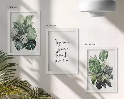 Bilderwand mit Motiv von grünen Tropenblättern und dekorativem Schriftzug