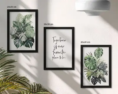 Bilderwand mit Motiv von grünen Tropenblättern und dekorativem Schriftzug