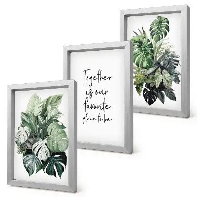 Bilderwand mit Motiv von grünen Tropenblättern und dekorativem Schriftzug